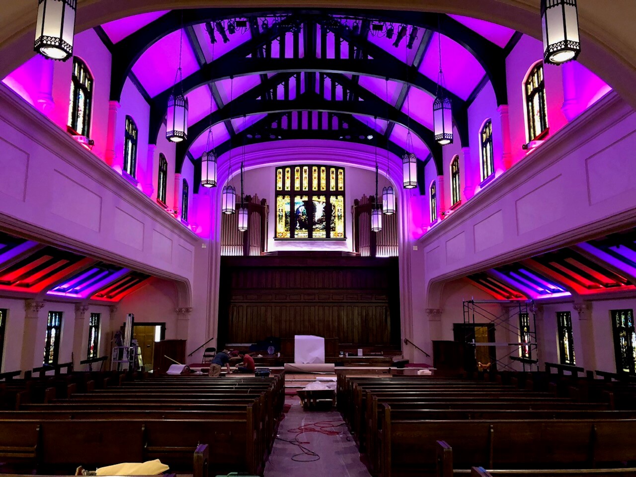 purple lighting in an arched building